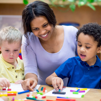 Teacher points at a photo in a student’s textbook in class