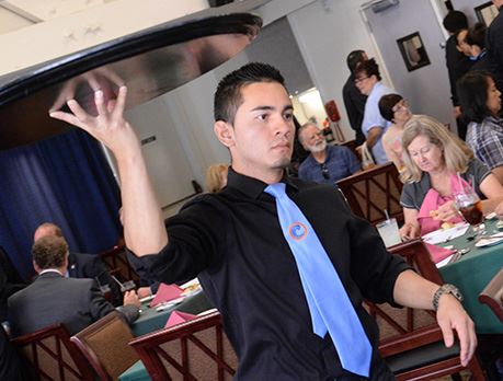 Waiter carries tray through busy dining room