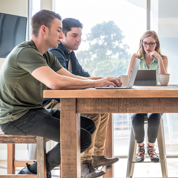 Group of students studying a table