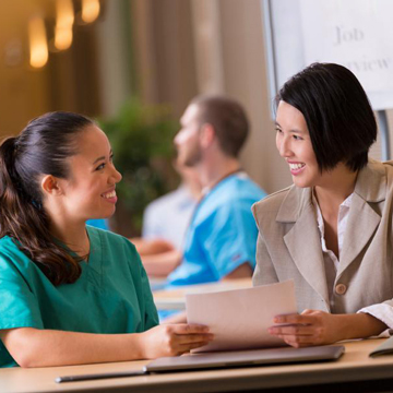 Two women working together at a table.