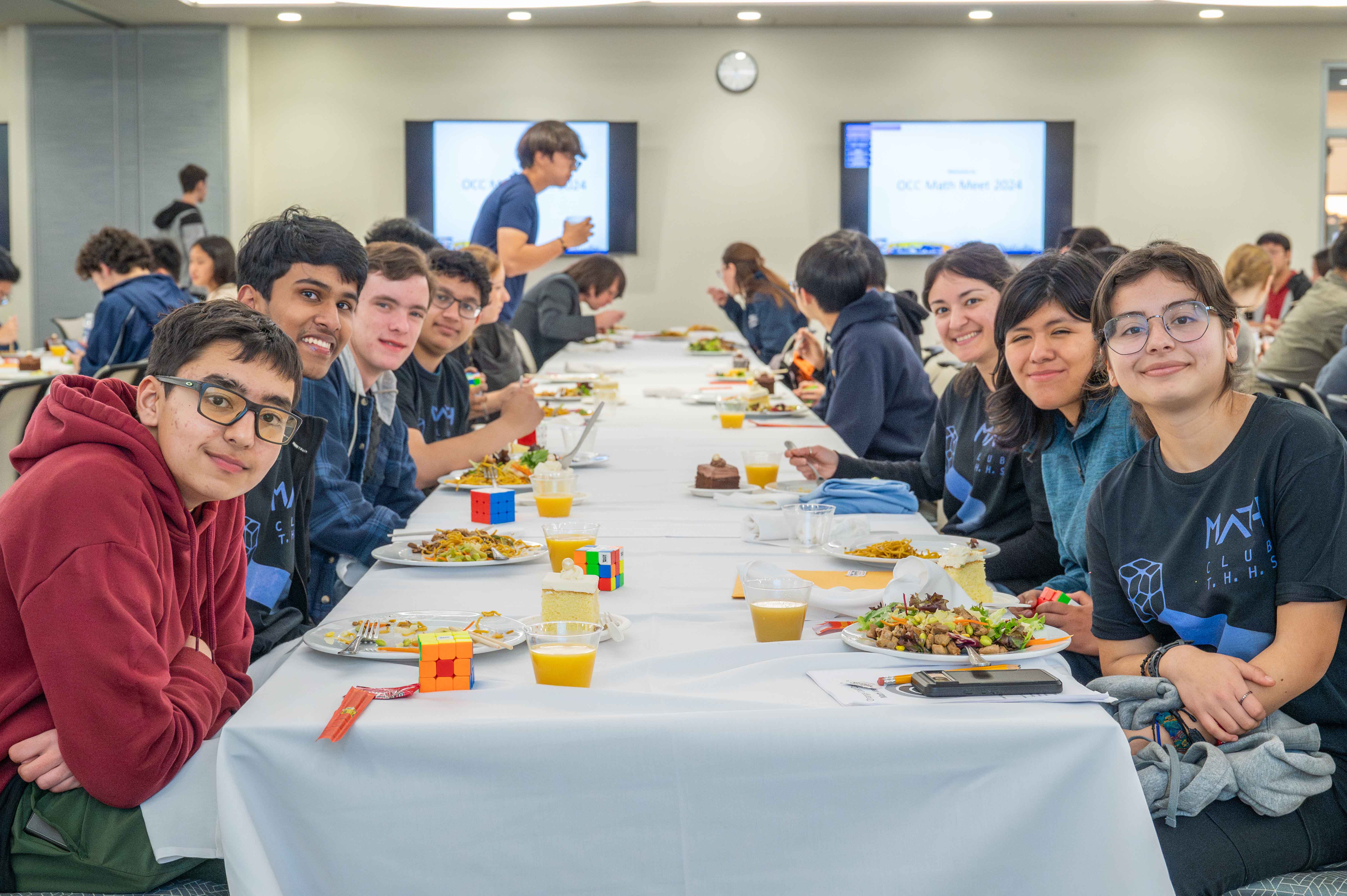 Students and advisors eat dinner while they await the results of the event