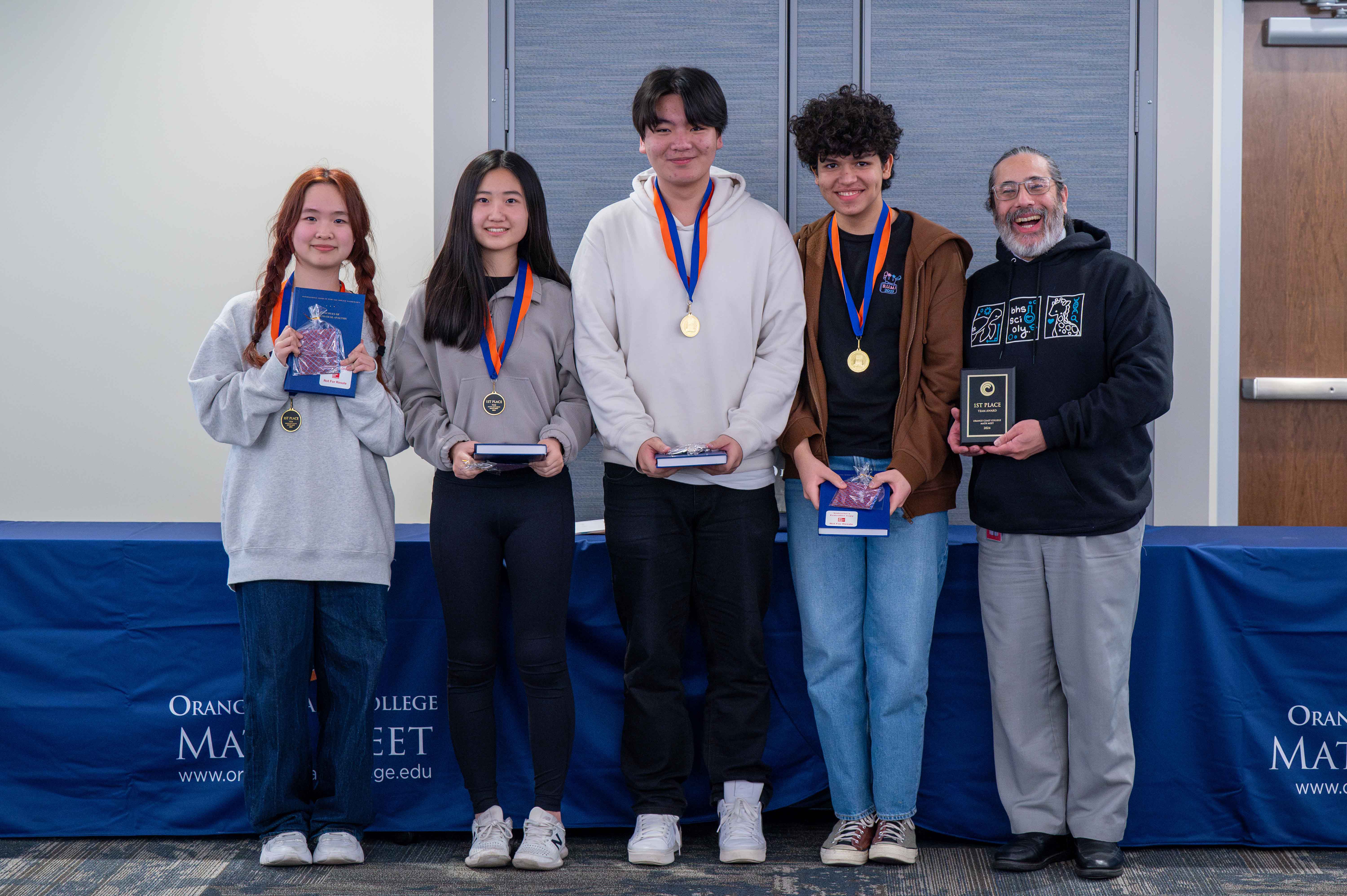 Beckman High School students receive their plaque and medals for winning the OCC Math Meet
