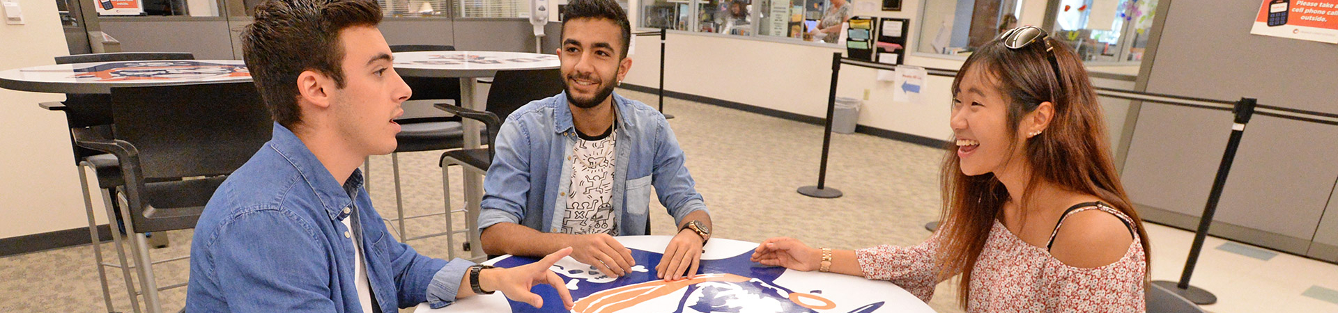 3 students talking in the Enrollment Center